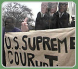 Man holding sign that reads, U.S. Supreme COURupTion